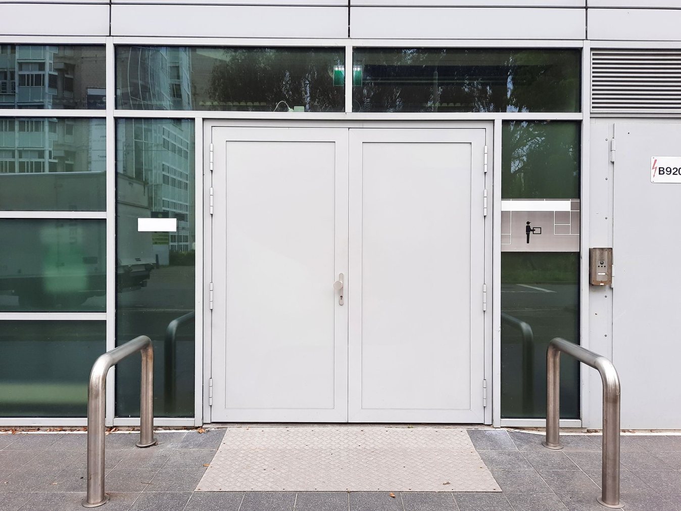 Modern glass commercial building entrance with double doors