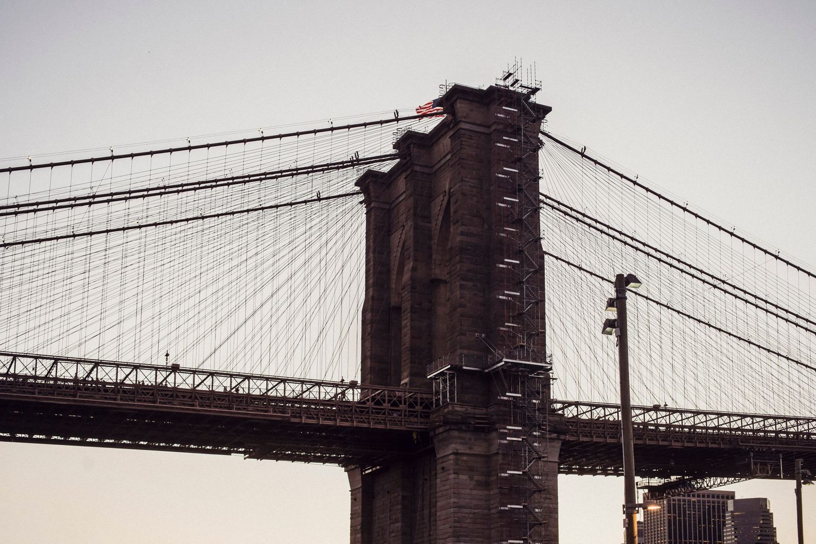 Brooklyn Bridge and New York City waterfront with historic brownstone buildings