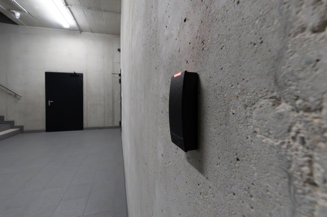 Electronic access control reader mounted beside a secured building door