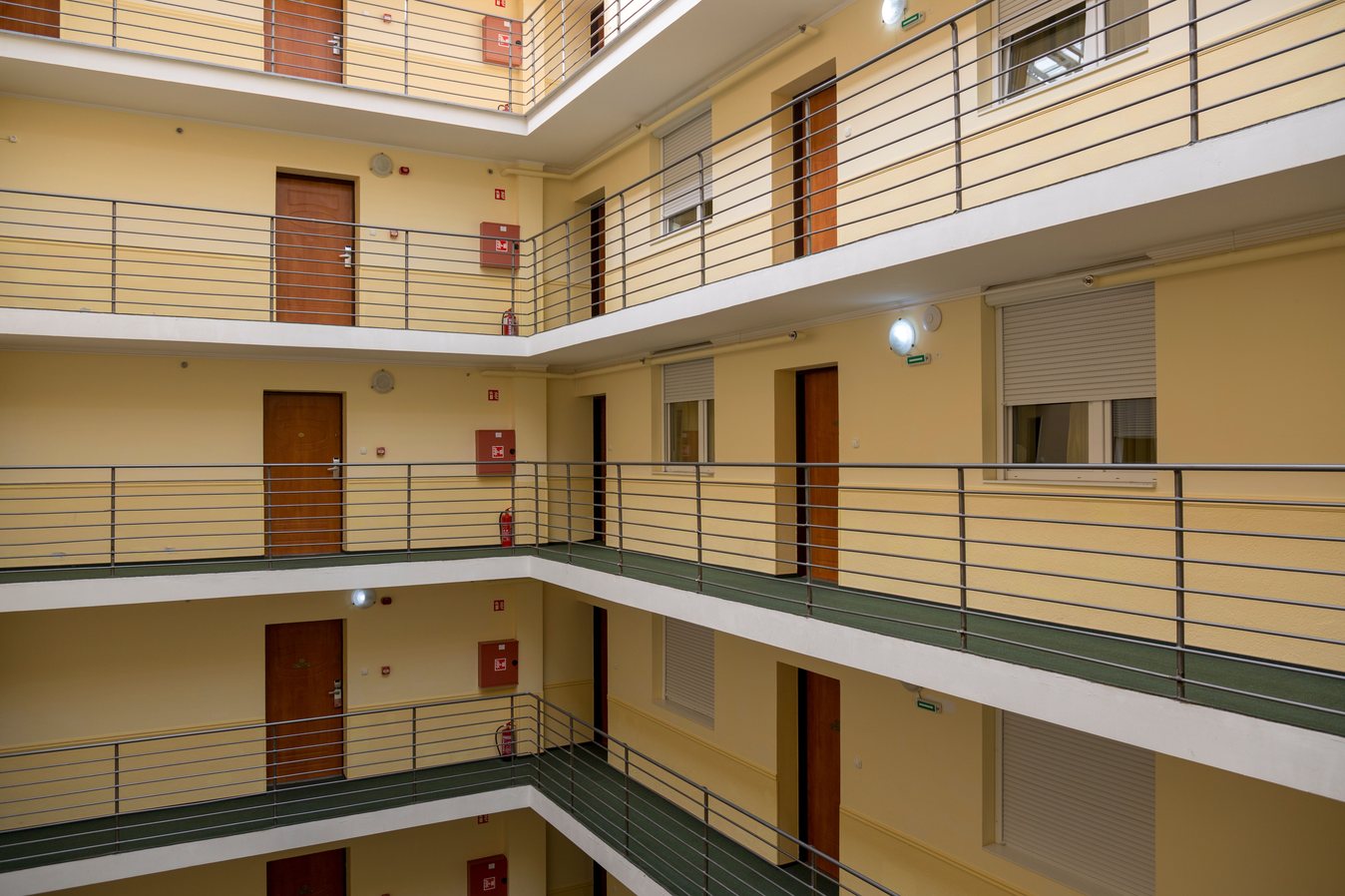 Apartment building interior walkways lined with apartment entrance doors