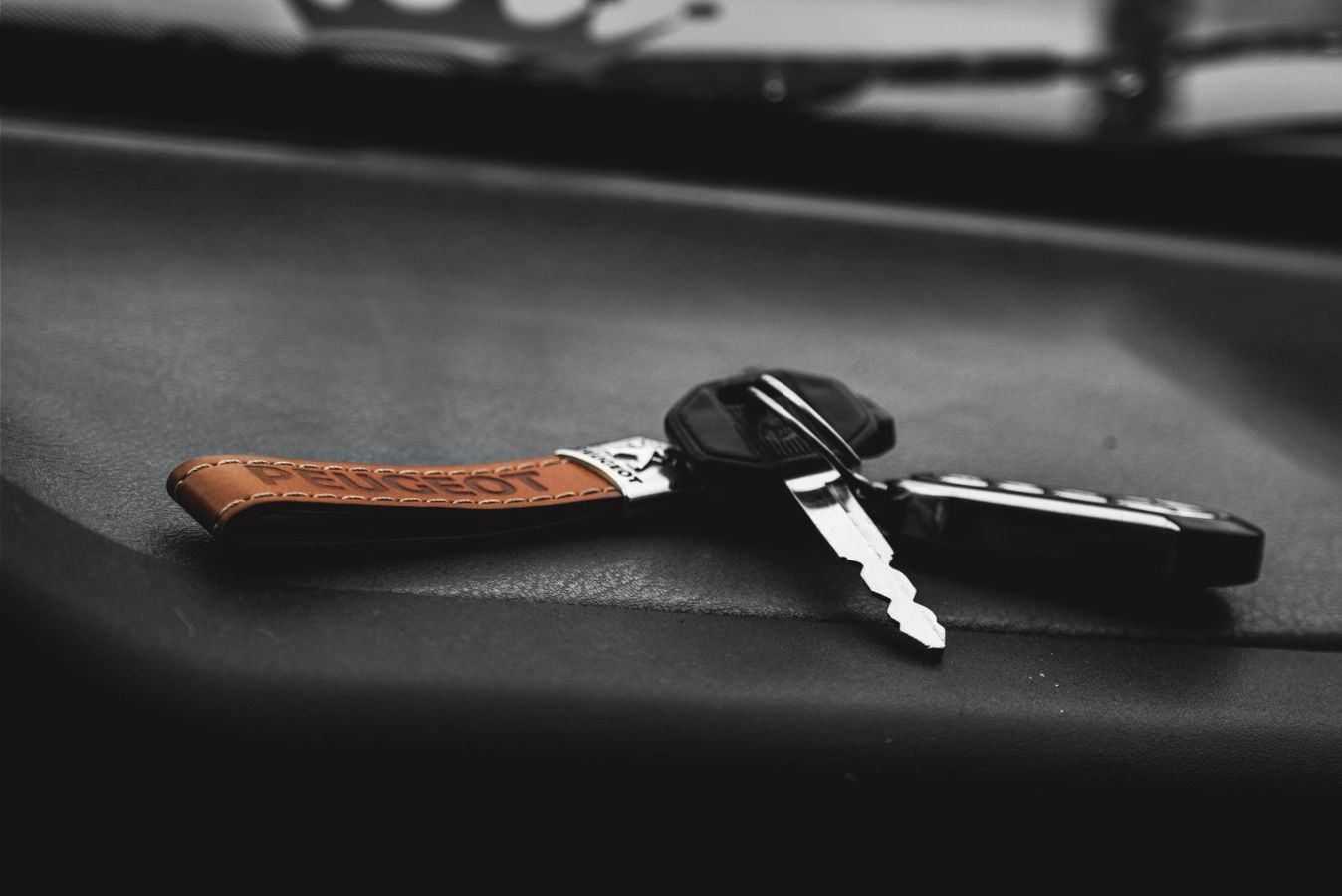 Car key with a leather keychain on a dark surface after being replaced in New York City