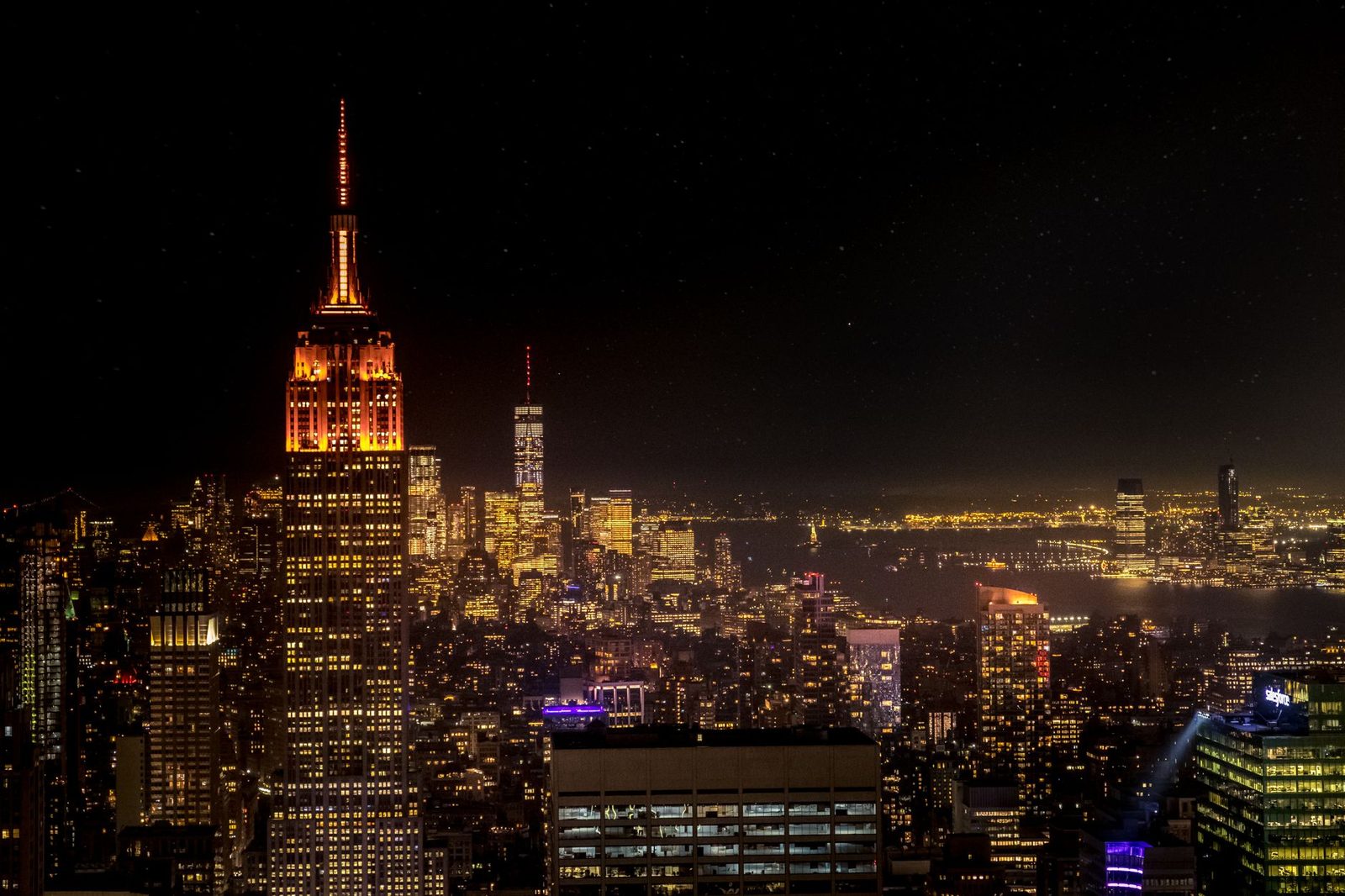 Manhattan skyline at night with illuminated skyscrapers across New York City