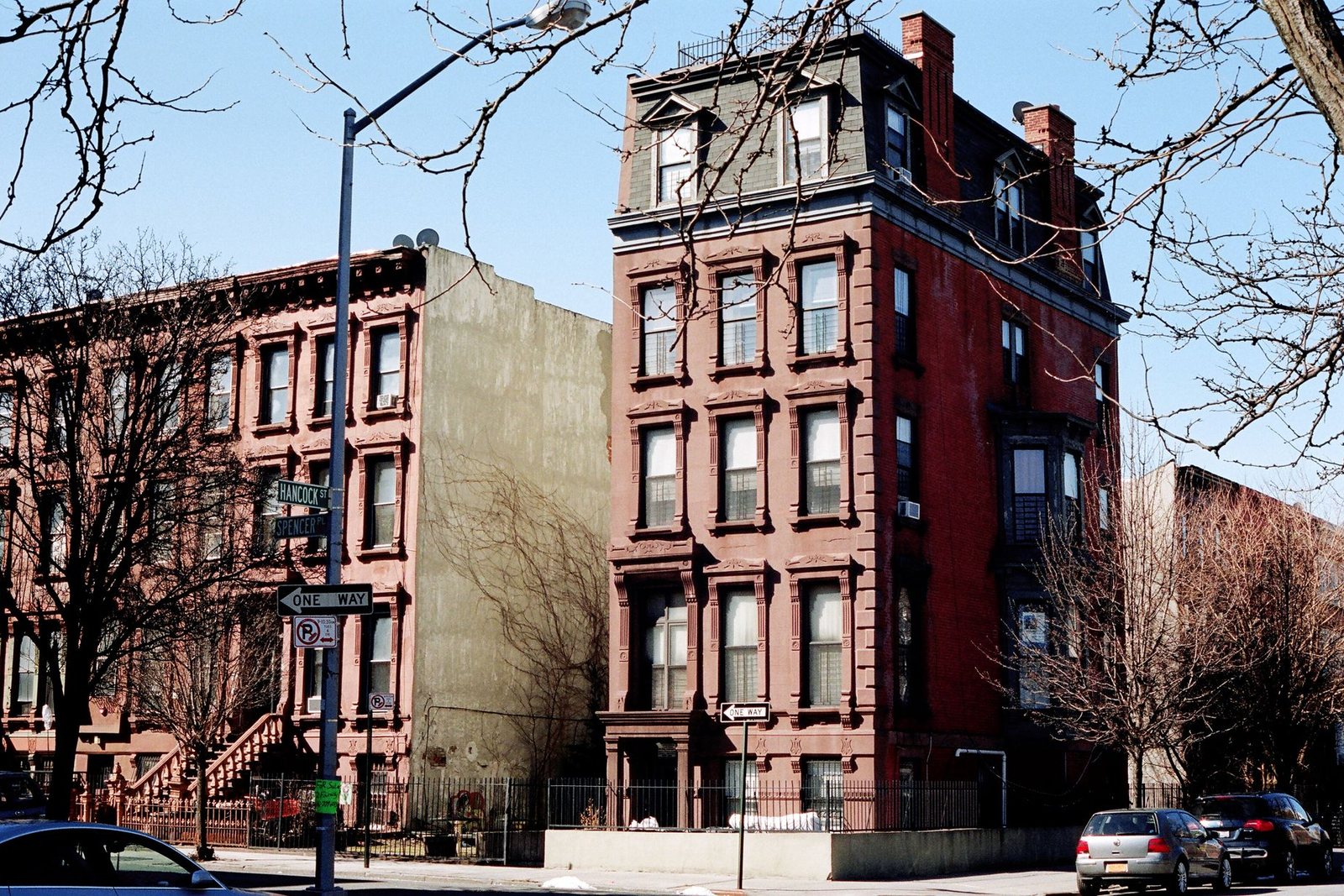 Row of Brooklyn brownstone entrances with stoops and original wood doors